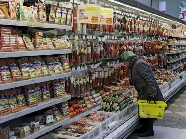A person buys food in a supermarket