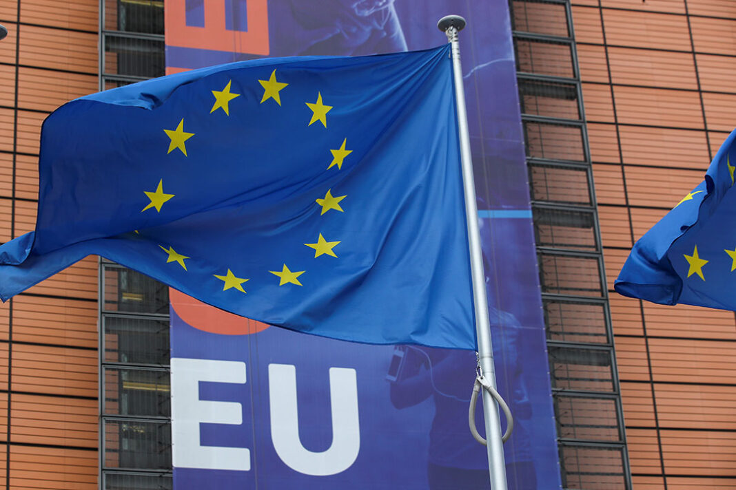 The EU flag in front of the European Council building.