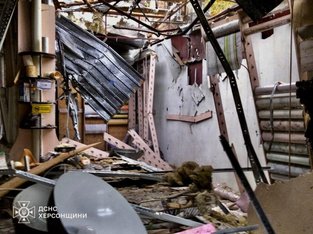 Rescuers work at the site of the shelling in Kherson.