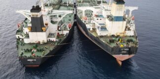 An Indian tanker transfers oil from a Russian vessel on the high seas