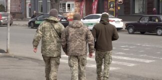 Employees of the TCC checking documents of persons liable for military service