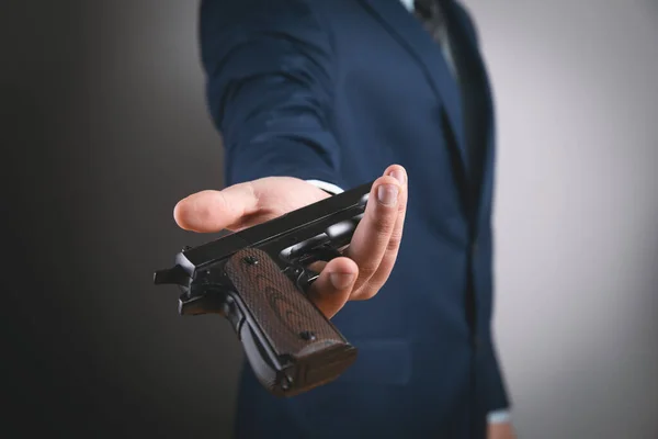 depositphotos_464703540-stock-photo-young-man-offers-black-pistol Цивільна зброя для українців