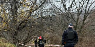 Police officers and bomb squad work at the scene of a terrorist attack in Dnipro