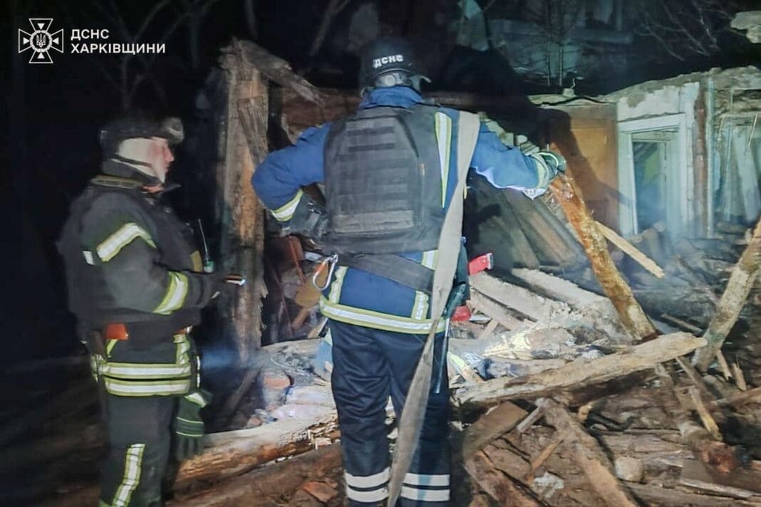 Rescuers work near a private house that caught fire after a Russian UAV attack in Kharkiv region.