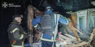 Rescuers work near a private house that caught fire after a Russian UAV attack in Kharkiv region.