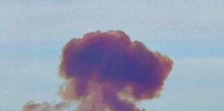 A purple-red mushroom-shaped cloud of smoke after an explosion at a missile test site near Orenburg