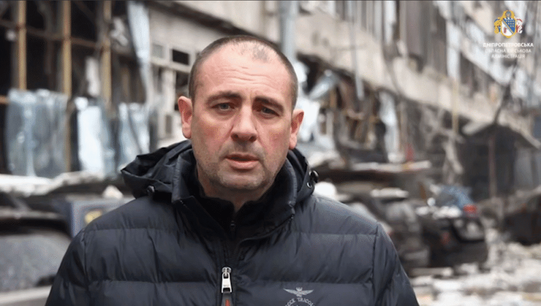 The head of the Dnipro Regional Military Administration in front of a destroyed building after a Russian missile strike.