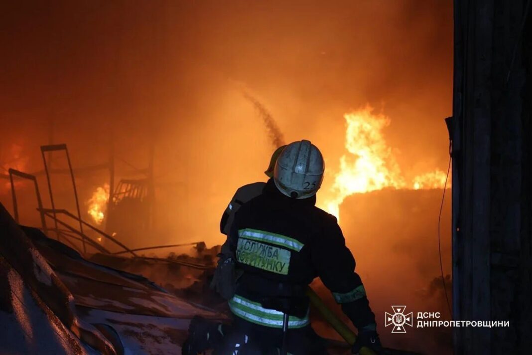 A rescuer extinguishes a large-scale fire at the Med-Service warehouse in Dnipro
