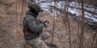 Ukrainian Armed Forces soldier installs equipment on the front line