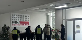 Police and journalists in the building after the attack in Kyiv