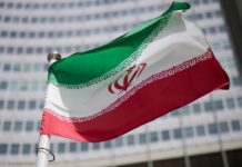 Iranian national flag in front of a government building