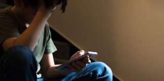 The child uses a smartphone and social media