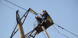 Power engineers repair the damaged power grid