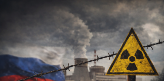 Radiation hazard sign on the background of an industrial facility