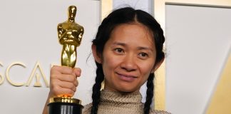 Chloe Zhao holds an Oscar