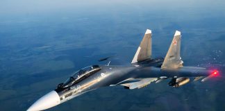 Su-30 fighter jet in flight over the sea