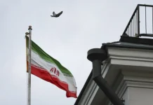 Iranian flag in front of Tehran