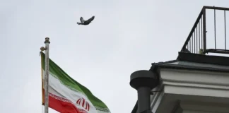 Iranian flag in front of Tehran