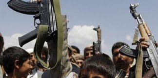 Armed children in the IRGC at an Iranian checkpoint