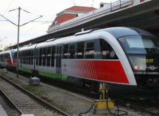 Пасажирський потяг на фоні залізничної станції