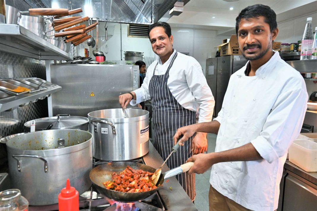 cook in the kitchen of a restaurant in India
