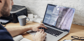 IEA calls for remote working due to oil crisis A man works from home on his laptop during the energy crisis.