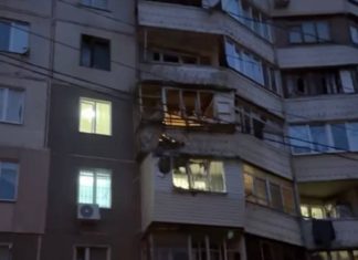 The destroyed facade of a multi-storey building after a drone strike in Odesa.