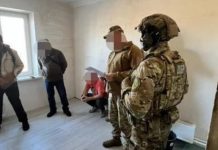 A house being repaired by military personnel