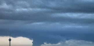 A picture of a thick smoke cloud over the city of Tehran.