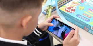 Council prepares smartphone restrictions for students A student holds a smartphone in the classroom during a lesson