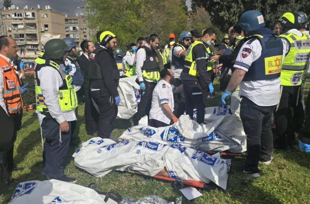 Rescuers work at the site of a rocket attack in Israel