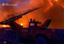 SES fire truck extinguishing a large fire at night