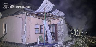 Rescuers extinguish a fire after a residential building was shelled.