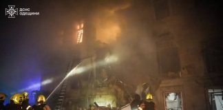 Firefighters work near a destroyed residential building in Odesa after shelling