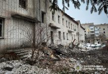 Consequences of shelling of a residential building in Sumy region, broken window and debris.