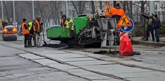 Repair work on a bridge in Kyiv with construction equipment