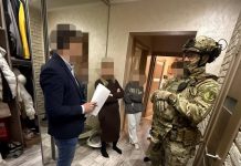 law enforcement officers conduct a search in the case of corruption in the TCC