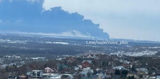 Smoke over an oil refinery