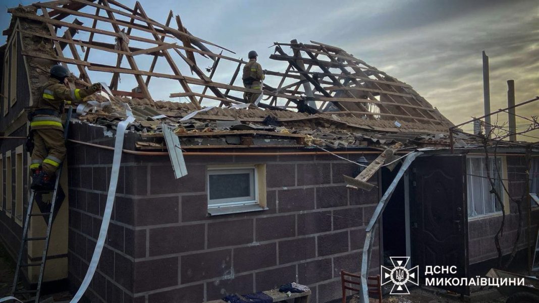 Firefighters near the damaged house