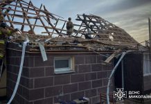 Firefighters near the damaged house