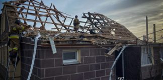 Firefighters near the damaged house