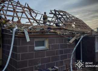 Firefighters near the damaged house