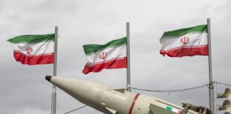 Iranian ballistic missile against the background of flags