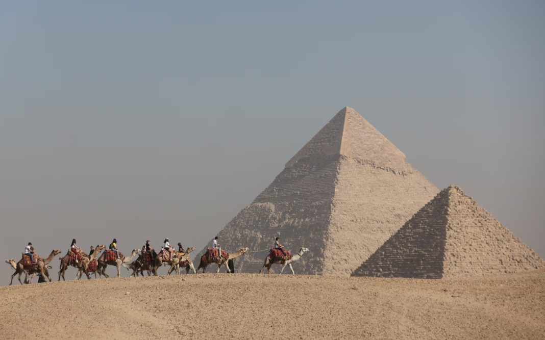 The Great Pyramid of Giza against the blue sky, view from below