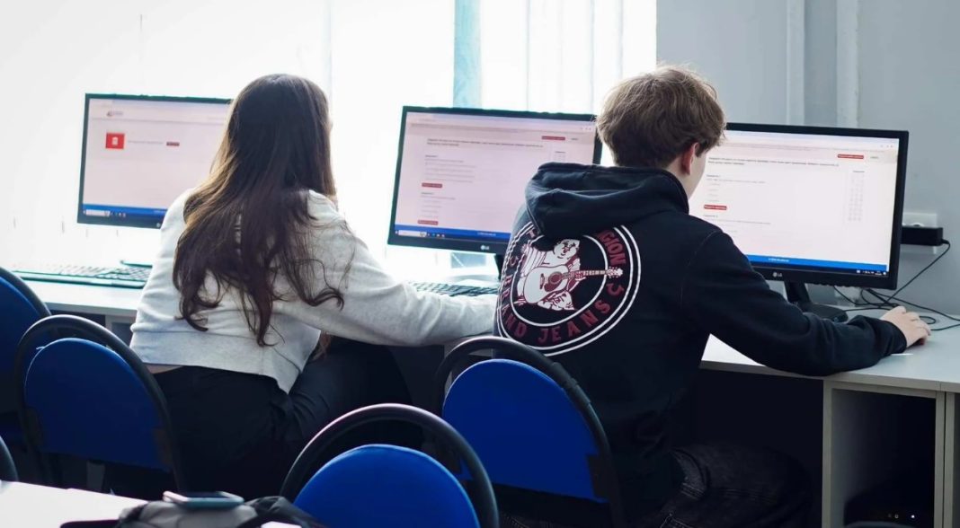 Students take a national multi-subject test in a school classroom.