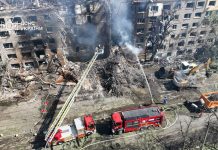 Almost 300 buildings damaged in Kyiv after Russian attack Rescuers work at the site of destruction after a rocket attack in Kyiv