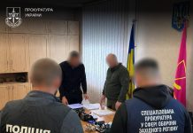 Prosecutors and police conduct a search