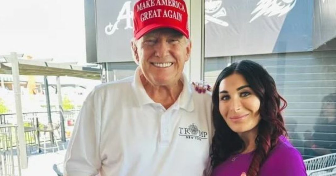 1200x630 American blogger Laura Lumer stands next to Donald Trump during a joint meeting.