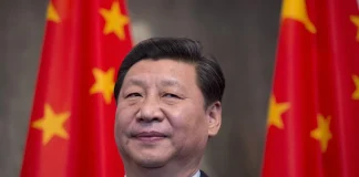 Chinese leader Xi Jinping in front of Chinese national flags before his official visit to North Korea.