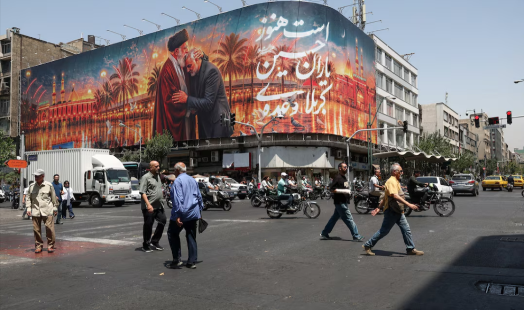 A street in Tehran featuring a large mural dedicated to Iran and its religious leadership
